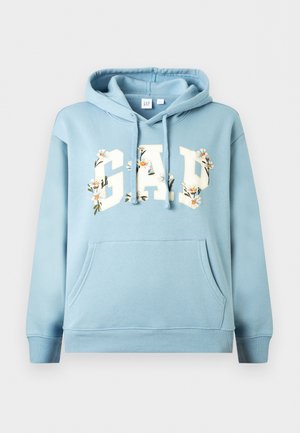 Hele sinine kapuutsiga dressipluus esitasku, paelte ja "GAP" kirjaga, mis on kaunistatud valgete ja oranžide lillemustritega.