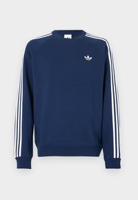 Φούτερ σε ναυτικό μπλε χρώμα με ριμπ μανσέτες και λαιμόκοψη· διαθέτει λευκές κάθετες ρίγες στα μανίκια και μικρό λευκό λογότυπο στο στήθος.