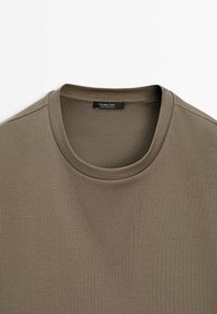 Brown crew neck cotton t-shirt with a visible black label stitched inside the collar reading "Massimo Dutti."