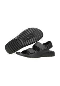 Schwarze Sandalen mit verstellbaren Klettverschlussriemen, einem strukturierten Fußbett und einer strapazierfähigen Gummisohle mit tiefen Rillen für beste Traktion.