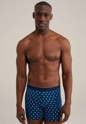 Boxers de marina con patrón de patos blancos, banda elástica y diseño ajustado. Tejido suave con una textura blanda.