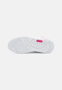 White sneaker sole with textured design, circular patterns, and pink accents. Features "LACOSTE" branding on the side.