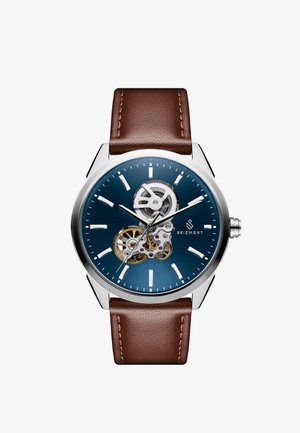 Mechanisk ur med blå skive, gennemsigtig bagkasse, sølv rustfrit stål urkasse og brun læderrem. Har minimale time markører.