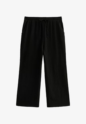 Zwarte wijde broek met elastische tailleband, trekkoord en zijzakken, gemaakt van gestructureerde stof.