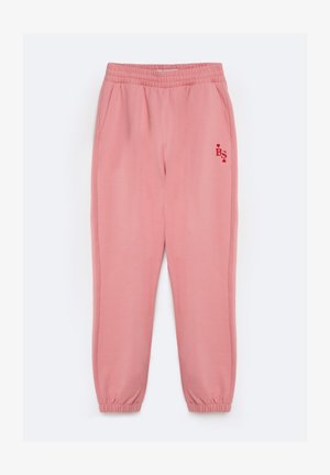 Pink sweatpants with an elastic waistband, side pockets, and elastic cuffs. Features a red logo with hearts on the left thigh.