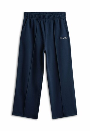 Marineblaue Sweatpants mit weitem Bein, elastischem Bund, Seitentaschen und weißem "Tommy Hilfiger"-Logo am rechten Oberschenkel.