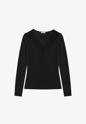 Black long-sleeve top with a V-neck featuring lace trim along the neckline. Smooth texture, fitted design, and solid color.