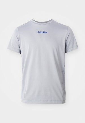 Light gray short-sleeve t-shirt made of textured fabric, featuring a blue "Calvin Klein" logo across the chest. Round neckline, regular fit.
