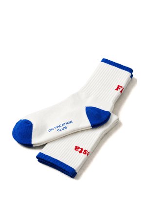 White ribbed socks with blue toes, heels, and cuffs, featuring red text on the cuff and blue text reading "ON VACATION CLUB" on the sole.