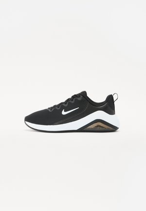 Black athletic shoe with a mesh upper, white midsole, and textured rubber outsole. Features a visible air unit and lace-up design.