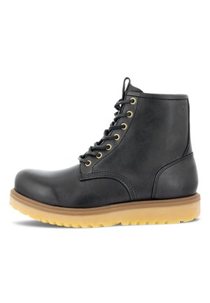 Black leather ankle boot with rounded toe, gold eyelets, lace-up closure, and a tan rubber sole featuring a textured pattern.