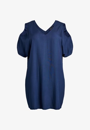 Haut bleu marine à manches courtes avec un col en V et des épaules découpées. Confectionné en tissu doux avec une texture lisse. Coupe légèrement ample.