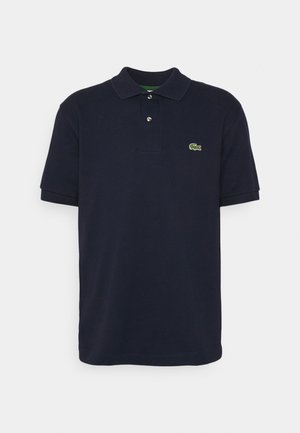 Navy blue polo shirt made of cotton, featuring a classic collar, short sleeves, three-button placket, and a small green logo on the chest.
