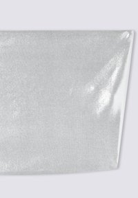 Srebrna tkanina brokatowa o gładkiej, błyszczącej powierzchni i miękkiej strukturze. Prostokątny kawałek jest starannie złożony w rogu.