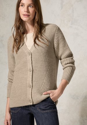 Gilet en tricot beige avec un motif côtelé texturé, en V, et fermeture à boutons. Manches longues, coupe décontractée et détails de poches latérales.