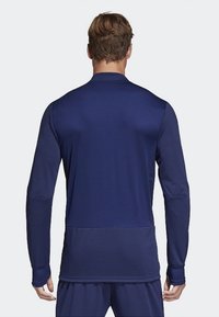 Marinblå långärmad träningsskjorta, har en hög krage och åtsittande manschetter, tillverkad av ett slätt, stretchy material med en ren design.