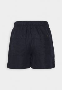 Navy blue linen shorts with an elastic waistband, featuring two back pockets and a subtle logo detail. Smooth texture, casual design.