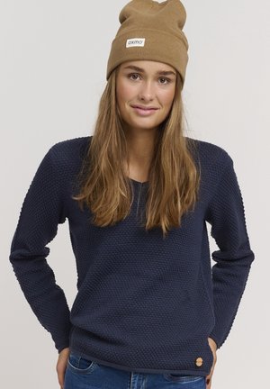 Navy blue knitted sweater with a textured pattern, round neckline, and long sleeves. Features a small branded tag on the lower side.