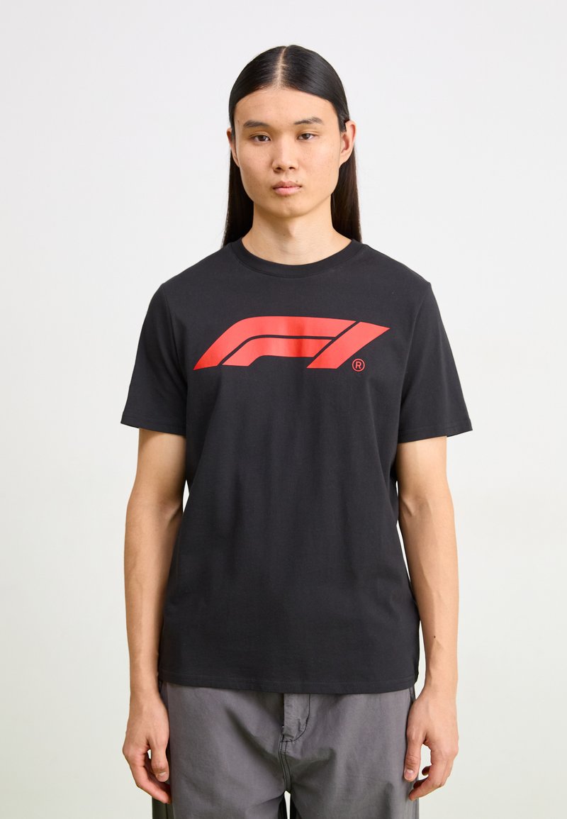 Black cotton t-shirt featuring a large red Formula 1 logo on the front. Short sleeves, crew neck, and a relaxed fit.