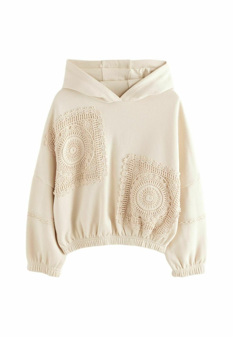 Beige cropped hoodie with a drawstring hood, featuring lace-like textured patches on the front and elastic cuffs and hem.