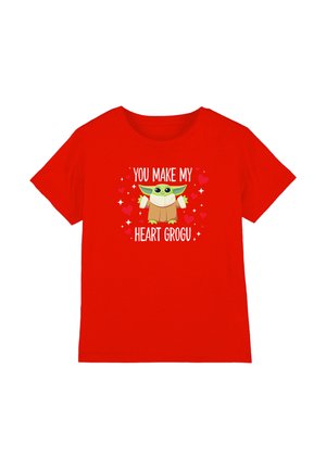 Red short-sleeve shirt with cartoon Grogu centered, surrounded by hearts, text above and below reads "YOU MAKE MY HEART GROGU."