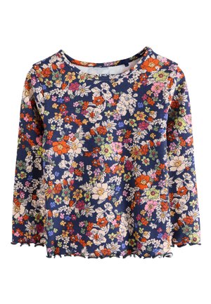 Haut à manches longues floral en bleu marine avec texture côtelée. Comprend des fleurs multicolores, un ourlet festonné et un col rond.