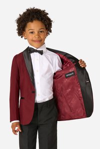 Burgundy suit jacket with black satin lapels, featuring a patterned inner lining labeled "OPPOSUITS." White dress shirt and bow tie complete the look.