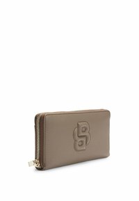 Brown textured leather wallet with a zip closure, featuring an embossed logo on the front and gold hardware accents along the zipper.