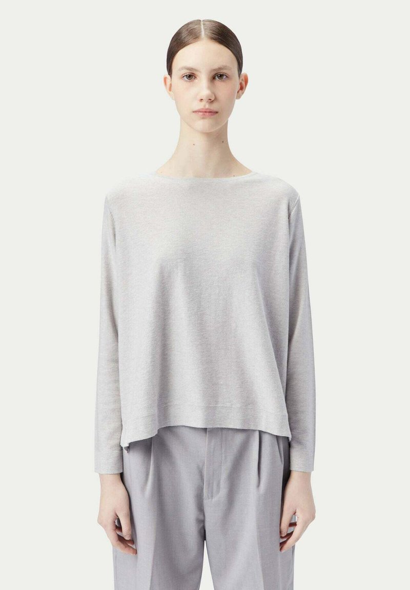 Ljusgrå, långärmad topp med bred halsringning och avslappnad passform, tillsammans med ljusgrå plisserade byxor. Mjukt tyg med subtil textur.