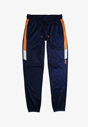 Marinblå träningsbyxor med orange och vita sidpaneler, elastisk midja med dragsko och elastiska muddar. USPA-logotyp på vänster ben.