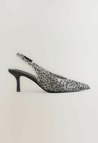 Slingback-High-Heel-Schuh mit spitzem Zehenbereich, ausgestattet mit einer schwarzen Basis und verziert mit silbernen und schwarzen Perlen für Textur und Detail.