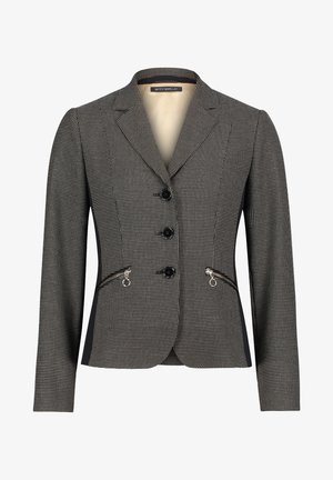 Skreddersyet blazer i sort og hvid hounds-tooth mønster med udskårne lapeller, tre knaplukninger og lynlåslommer i siderne. Glat tekstur.
