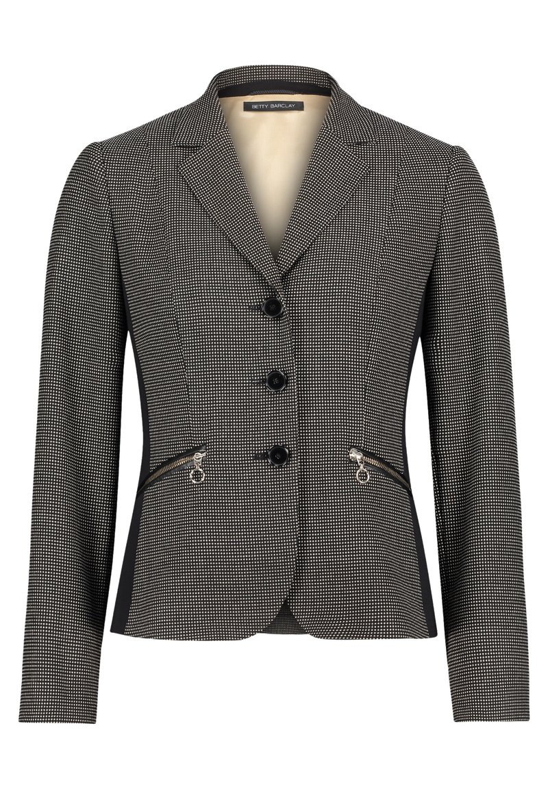 Skräddarsydd kavaj i svart och vitt houndstooth-mönster med slag, tre knappstängningar och dragkedjefickor på sidan. Slät textur.