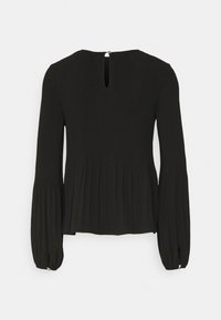 Top lungo a maniche ribbed nere con dettaglio a chiave sul retro, vita plissettata e maniche leggermente gonfie con bottoni decorativi.