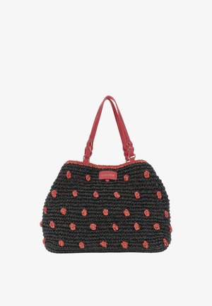 Sac à main tissé noir avec des pois rouges, des poignées en cuir rouge et une étiquette rouge portant l'inscription "CAPENDIR" sur le devant.