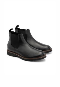 Czarne skórzane botki chelsea z elastycznymi bocznymi panelami, pętlami do zakładania, zaokrąglonymi czubkami i teksturowanymi gumowymi podeszwami. Minimalistyczny design i gładkie wykończenie.