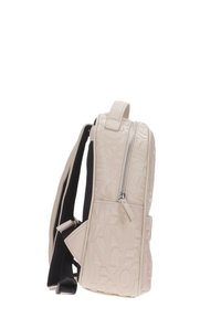 Zaino rettangolare beige con lettere in rilievo, spallacci neri imbottiti, manico superiore e tasca con cerniera frontale, visto di lato.