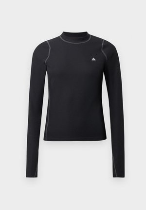 Černý top s dlouhým rukávem a vysokým límcem, texturovaný materiál a kontrastní švy. Má malé logo na hrudi a přiléhavý design.