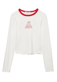 Valkoinen pitkähihaistoppi, jossa on punainen pyöreä pääntie, jossa on karhukuva ja "LEAGUE ROYALTY" -teksti punaisena. Puuvillasekoite.