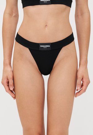 Black thong underwear with a wide elastic waistband featuring a white logo. Made from a smooth, stretchy fabric for comfort.