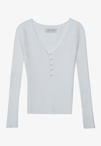 Vitt ribbat långärmad topp med V-ringning, med en femknappars knappslå dekorerad med små pärlliknande detaljer. Lappen säger "ANNA FIELD."