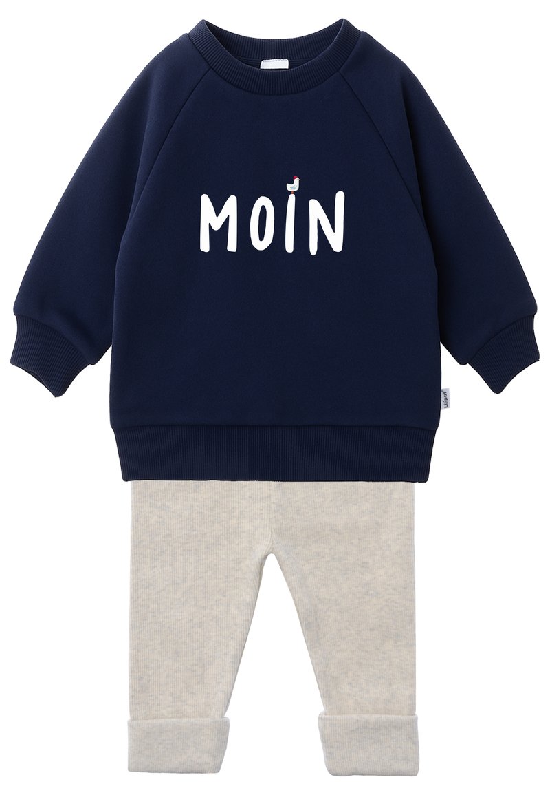Navy blue cotton sweatshirt with “MOIN” in white letters, paired with light gray ribbed leggings. Sweatshirt features ribbed cuffs and hem.