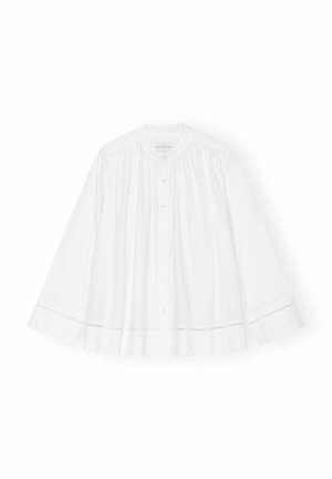 Blusa bianca in cotone con maniche lunghe, scollo rotondo, chiusura frontale con bottoni e dettagli plissettati. Presenta rifiniture in pizzo su polsini e orlo.