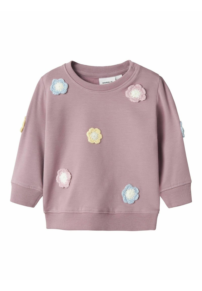 Felpa rosa con scollo rotondo, caratterizzata da applicazioni di fiori all'uncinetto multicolori. Maniche lunghe e polsini a coste. Texture morbida.