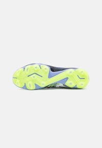Multicolored athletic shoe sole featuring a textured yellow rubber base with a zigzag pattern and a mix of blue and black accents.