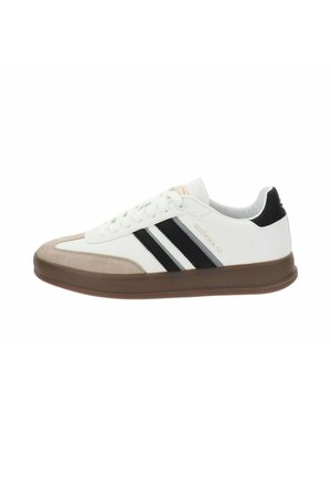 Zapatilla blanca con rayas negras y suela de goma marrón. Presenta un upper de cuero suave y una puntera de ante. Cuerdas y logo incluidos.