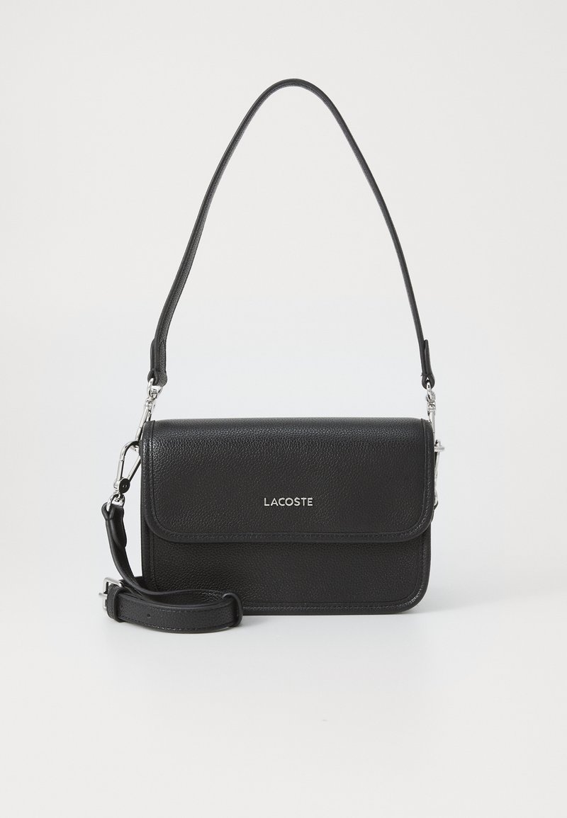 Black leather crossbody bag with a textured finish, magnetic flap closure, adjustable strap, and silver logo on the front.