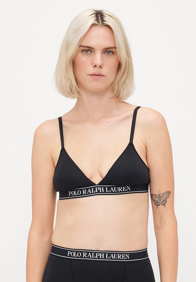Black ribbed bralette with thin adjustable straps and a logo band reading "POLO RALPH LAUREN." Features a triangular cup shape.