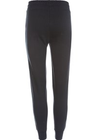 Svarta joggerbyxor med elastisk midja, smalnande ben och ribbade muddar. Tillverkade av mjukt, slätt tyg utan synliga mönster.