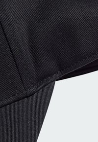 Black fabric with a diagonal striped texture, featuring a neatly stitched edge. The material appears sturdy and durable.